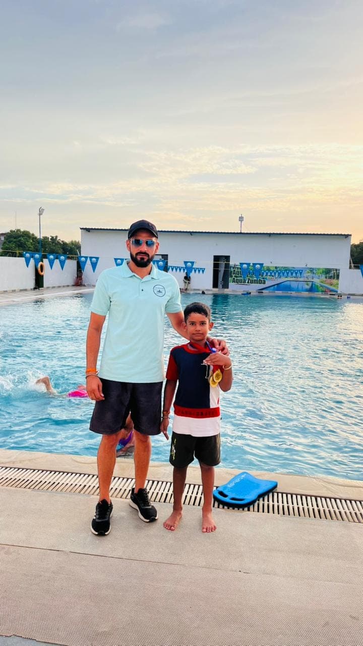 Coach guiding a first-time swimmer