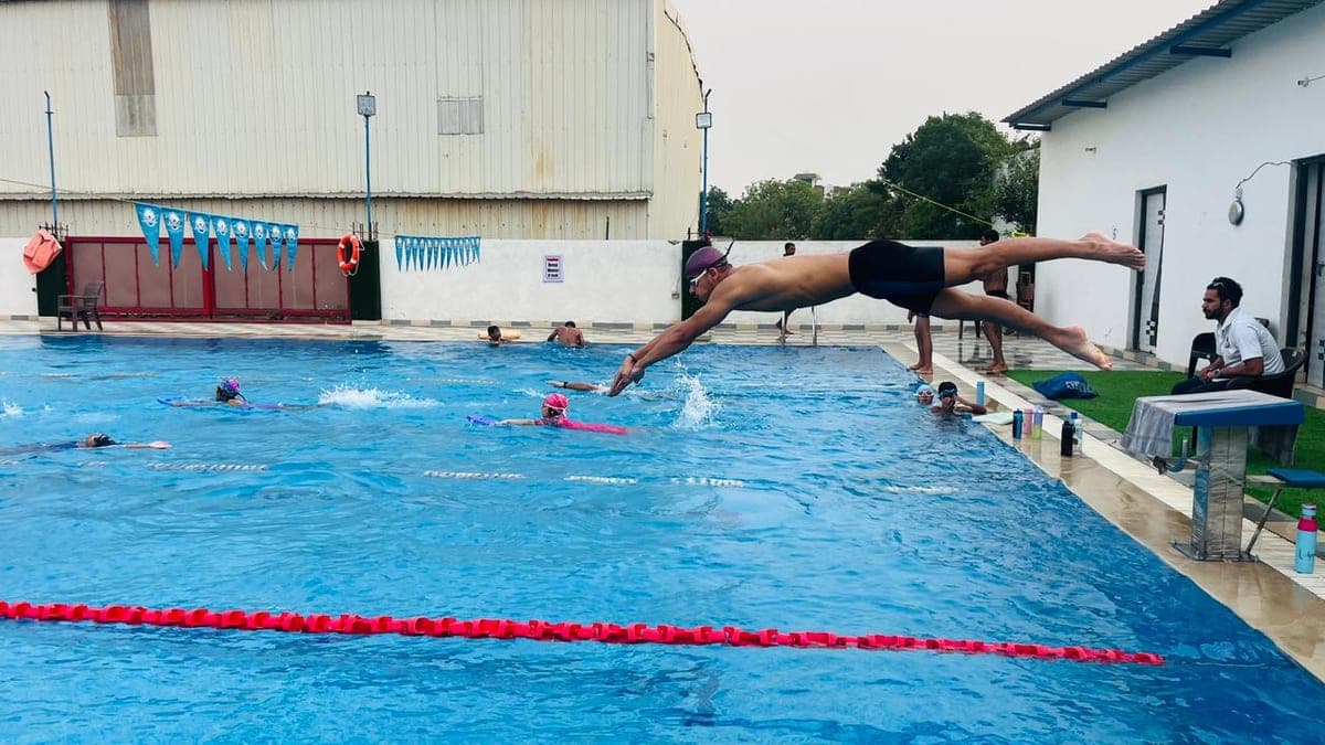 Swimmers training in lanes during an evening batch at The Breathe Swimming Academy in Sector 50, Gurgaon